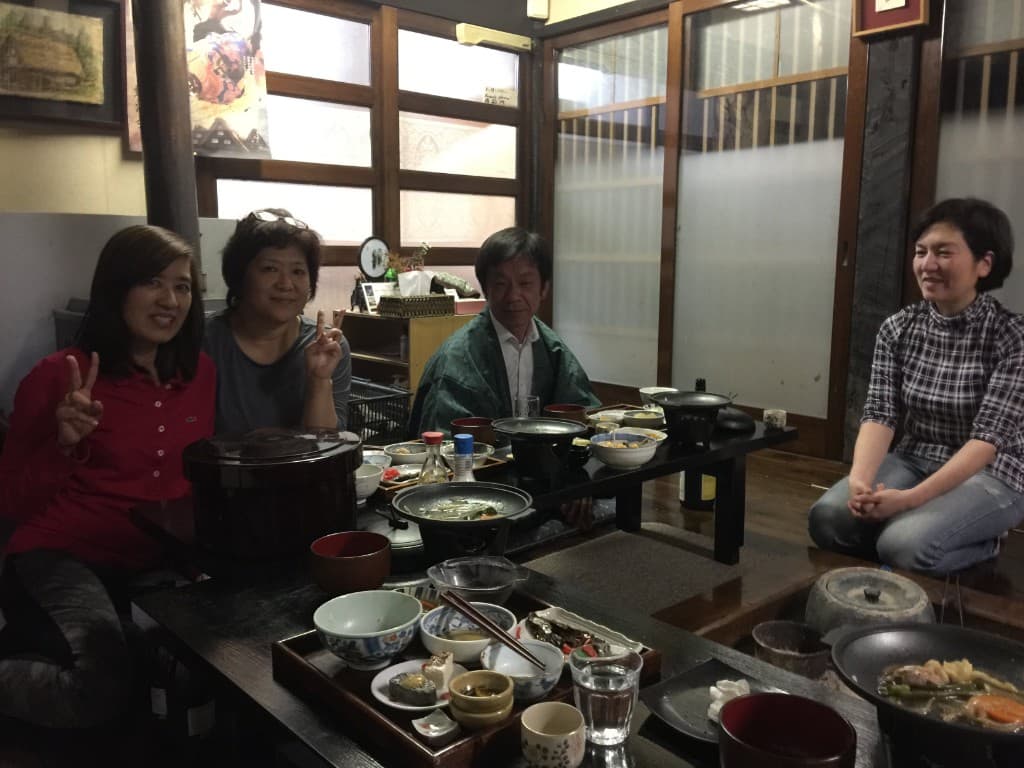 Guests enjoying a traditional farmhouse dinner at Shimizu Inn